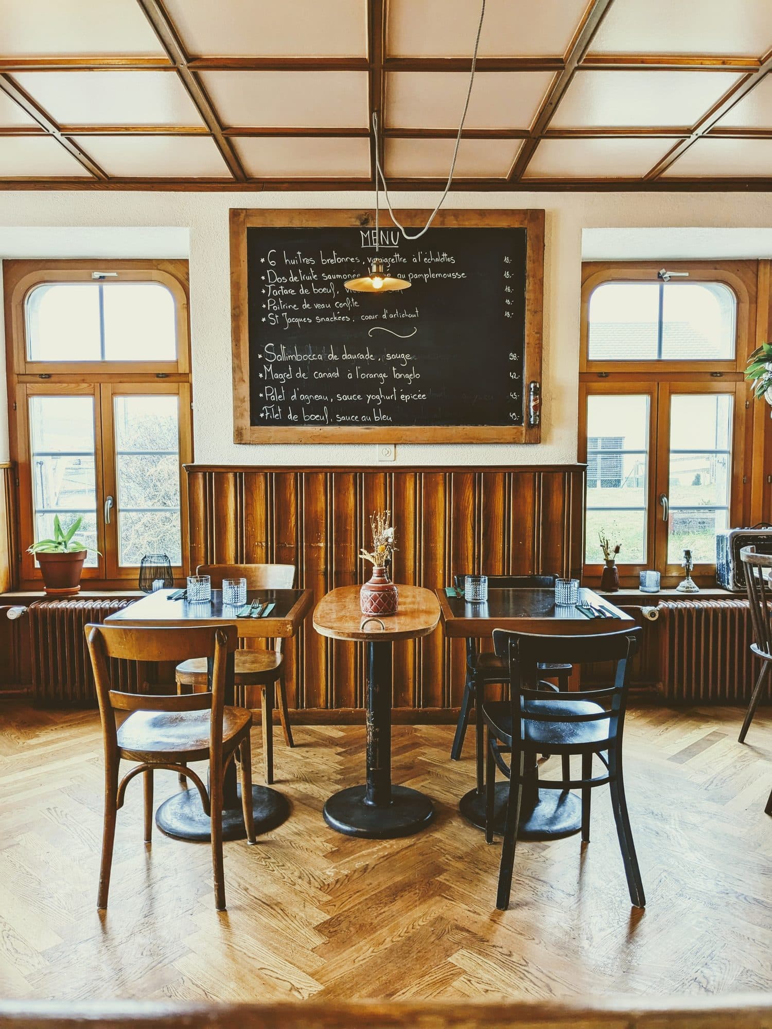 La salle du bistrot, ses boiseries et son ardoise du jour